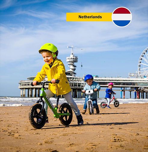 Netherlands - Children on Strider Bikes on beach
