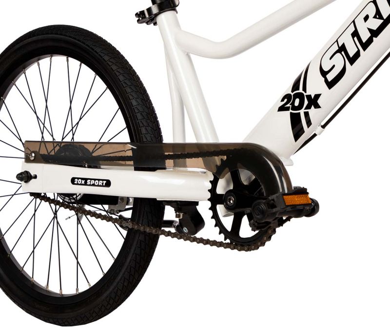 A studio detail of the pedals and chainguard on the Strider 20x Sport, a 20" all-in-one balance and pedal bike