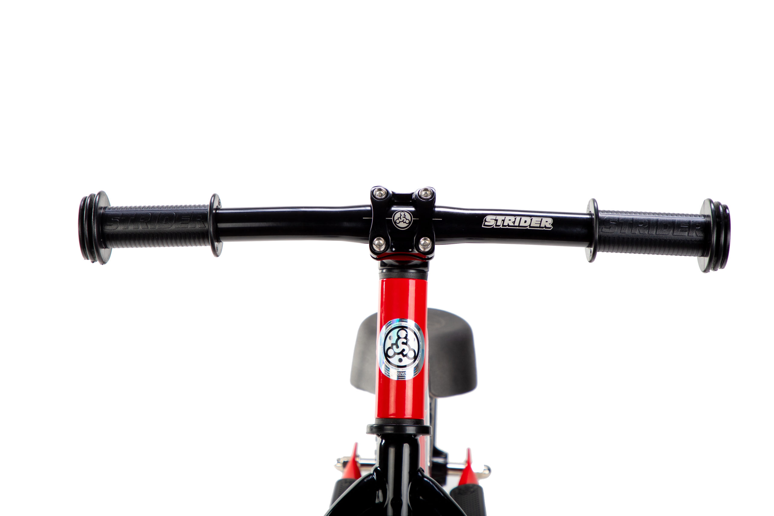 Studio image of Strider Aluminum Flat Handlebar with Grips on red 12 Sport - close-up front view